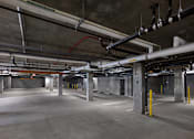 Thumbnail 15 of 94 - A large, empty parking garage with concrete floors and multiple levels of parking.