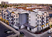 Thumbnail 14 of 94 - A parking lot in front of a building with a yellow stripe.