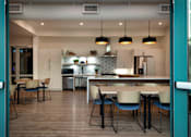 Thumbnail 87 of 90 - A modern kitchen with a dining table and chairs.