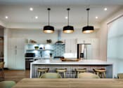 Thumbnail 83 of 90 - A modern kitchen with a dining table and chairs.