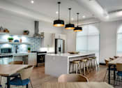 Thumbnail 84 of 90 - A modern kitchen with a dining table and chairs.