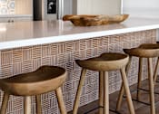 Thumbnail 73 of 90 - Four wooden bar stools in front of a bar counter.