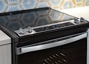 Thumbnail 53 of 90 - A modern oven with a stainless steel finish and a glass door.