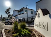 Thumbnail 37 of 90 - A sign that reads "Salida del Sol" is in front of a building.