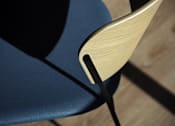 Thumbnail 44 of 90 - A blue chair with a wooden backrest and black metal legs.