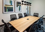 Thumbnail 43 of 90 - A conference room with a long table and chairs.