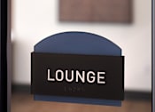 Thumbnail 52 of 90 - A sign that says "LOUNGE" is in front of a painting.
