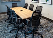 Thumbnail 41 of 90 - A conference room with a large table and chairs.