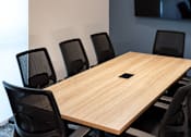 Thumbnail 38 of 90 - A conference room with a long table and chairs.