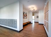 Thumbnail 55 of 90 - A long hallway with a bench and pictures on the wall.