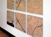 Thumbnail 4 of 90 - A wall with four paintings of maps on it.
