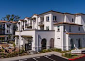 Thumbnail 3 of 90 - A white building with a sign that says Salida del Sol.