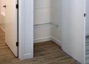 Thumbnail 25 of 90 - A white pantry with an open door.
