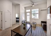 Thumbnail 23 of 90 - A modern dining room with a wooden table and chairs.