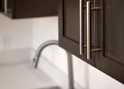 Thumbnail 12 of 90 - A close up of a kitchen sink with a chrome tap.