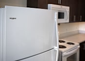 Thumbnail 17 of 90 - A white Whirlpool refrigerator in a kitchen.