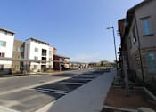 Thumbnail 1 of 25 - A street view of a residential area with houses on both sides.