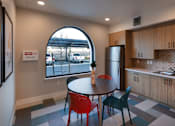 Thumbnail 8 of 61 - A kitchen with a round table and chairs with a window in the background.