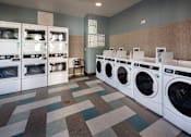 Thumbnail 49 of 61 - A laundromat with a variety of washing machines.