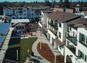 Thumbnail 16 of 61 - A view of a courtyard with a blue tarp covering a building.