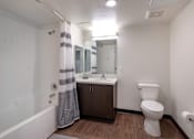 Thumbnail 116 of 127 - A white toilet sits next to a sink in a bathroom.