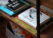Thumbnail 107 of 127 - A stack of books on a shelf with a book titled "No Way Home" on top.