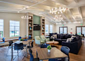 Thumbnail 101 of 127 - A modern living room with a dining table and chairs.