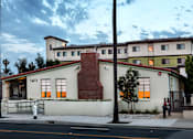 Thumbnail 91 of 127 - A white building with a red roof and a number 1411 on it.