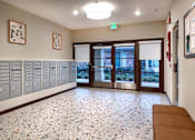 Thumbnail 81 of 127 - A hallway with a bench, lockers, and a bulletin board.