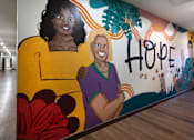Thumbnail 71 of 127 - A mural of two women with the word "hope" written above them.