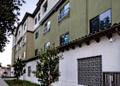 Thumbnail 77 of 127 - A white building with green trim and windows.