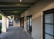 Thumbnail 79 of 127 - A long hallway with doors on both sides.