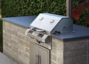 Thumbnail 82 of 127 - A modern outdoor kitchen with a grill and oven.