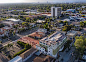 Thumbnail 53 of 127 - A cityscape with a mix of residential and commercial buildings.