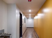 Thumbnail 62 of 127 - A long hallway with a red light on the ceiling.