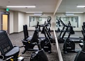Thumbnail 60 of 127 - A gym with treadmills and exercise bikes.