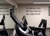 Thumbnail 61 of 127 - A gym with a motivational quote on the wall.
