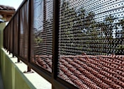 Thumbnail 28 of 127 - A close up of a brown mesh fence.