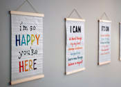 Thumbnail 34 of 127 - Four posters with positive affirmations are displayed on a wall.