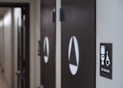 Thumbnail 24 of 127 - A sign on a door indicates that it is a restroom.