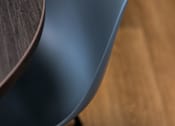 Thumbnail 26 of 127 - A blue chair with a wooden table in front of it.