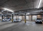 Thumbnail 8 of 127 - A parking garage with multiple cars parked.