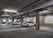 Thumbnail 10 of 127 - A parking garage with cars parked in it.