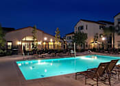 Thumbnail 102 of 117 - A swimming pool surrounded by lounge chairs and trees.