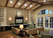 Thumbnail 100 of 117 - A living room with a fireplace and a television.
