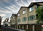 Thumbnail 92 of 117 - A row of houses with green shutters on the windows.