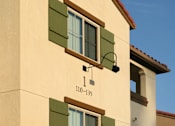 Thumbnail 88 of 117 - A building with a red tile roof and a sign that reads "110-135" is shown.