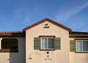 Thumbnail 96 of 117 - A house with a red tile roof and a window with green shutters.