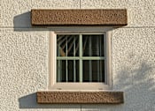 Thumbnail 71 of 117 - A window with a brown frame is on a light-colored wall.