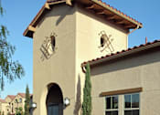 Thumbnail 63 of 117 - A small building with a brown roof and a clock on it.